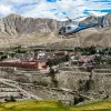 Aerial helicopter view over the arid cliffs and Tibetan-style villages of Upper Mustang, Nepal Himalayas