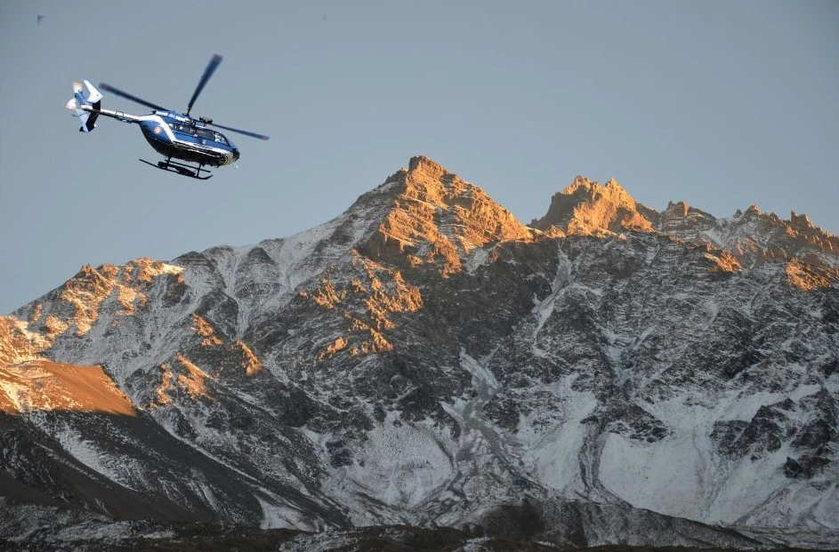 Helicopter view flying towards Muktinath Temple in the Mustang region of Nepal, with views of the Himalayas