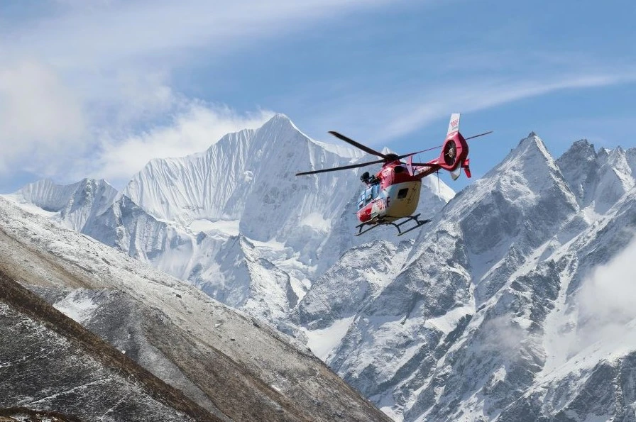 Helicopter flying over Langtang Valley with snow-capped Langtang Lirung peak and glaciers for Kyanjin Gompa helicopter tour from Kathmandu